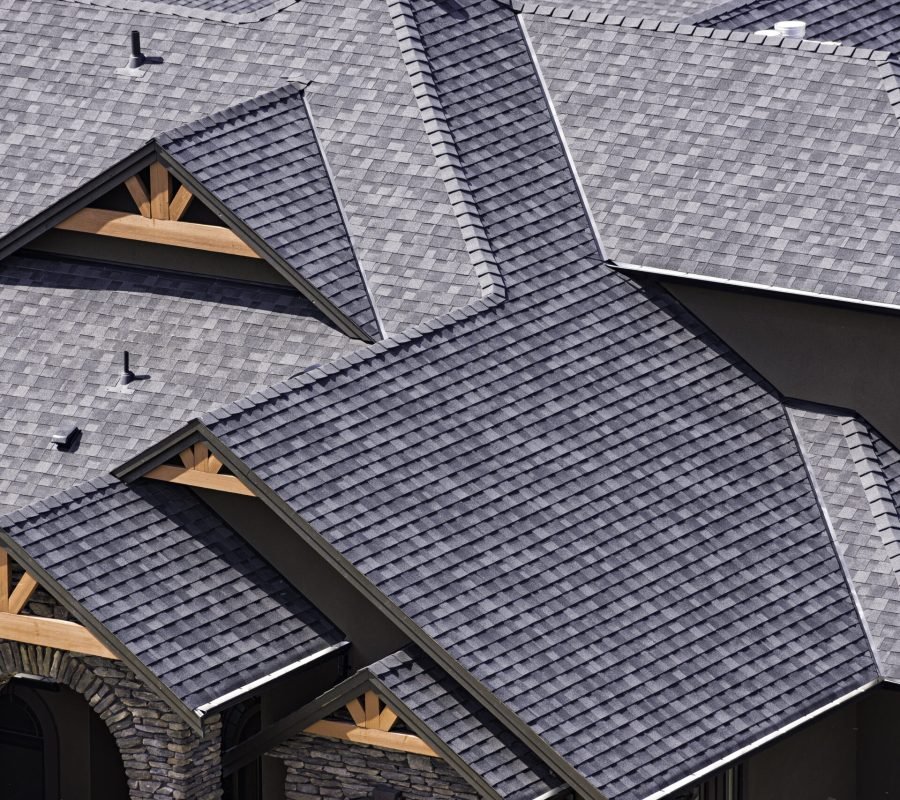 Rooftop in a newly constructed subdivision in Kelowna British Columbia Canada showing asphalt shingles and multiple roof lines